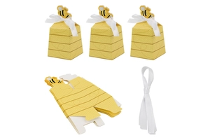 Flat lay showing unassembled flat pack honeybee gift boxes with white ribbons and 3D bee toppers