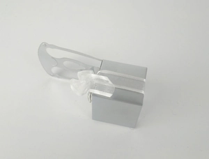 Detail of silver wedding candy box with white organza ribbon and hollow metal ornament