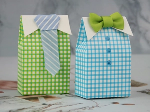 Detailed view of plaid shirt style candy boxes with 3D fabric necktie and bowtie decor
