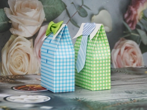Detailed view of creative shirt-shaped wedding candy boxes with bowtie and tie accents