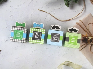 Detail of My Little Man candy boxes with bowties and mustache toppers for baby showers