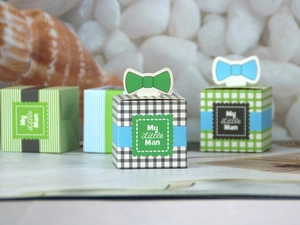 Detail of My Little Man gift boxes with striped patterns and bow-tie toppers for parties