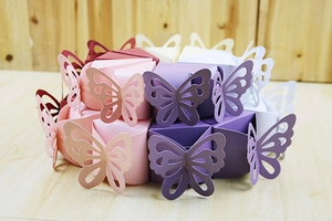 Detailed view of colorful butterfly laser-cut paper boxes arranged in a round cake shape
