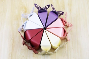 Close-up of butterfly hollow-out candy boxes arranged in a circular cake shape