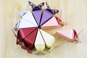 Detailed laser cut butterfly hollow patterns on colorful triangle candy gift boxes