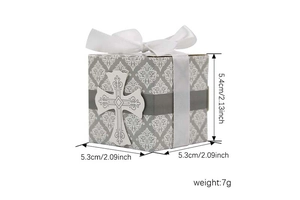 Detail of European candy box with damask pattern, white cross, and satin ribbon bow