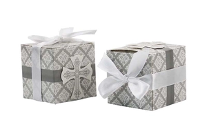Detail of white damask candy boxes with satin ribbons and silver hollow cross accents