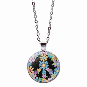 Detail of silver chain necklace with a colorful floral glass pendant on white background