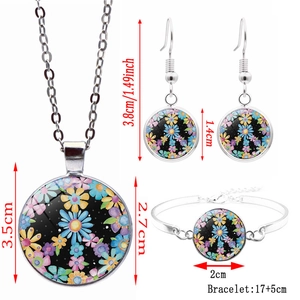 Silver peace sign jewelry set with colorful daisy floral pattern in glass cabochon