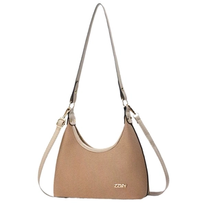 Elegant crescent-shaped canvas shoulder bag with beige leather trim and golden ZZMY logo