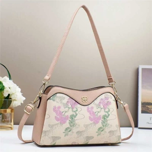 Floral embroidery shoulder bag with pink leather trim and elegant golden hardware