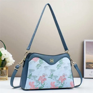Floral patchwork crossbody bag in dusty blue leather with gold clover hardware detail