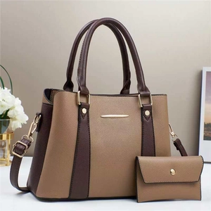 Macro view of khaki and dark brown patchwork tote bag with matching envelope wallet
