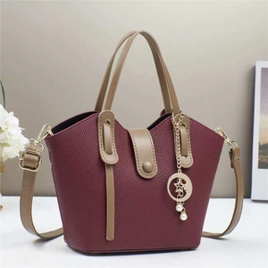 Burgundy bucket bag with wave-edge design and star moon pearl pendant accessory