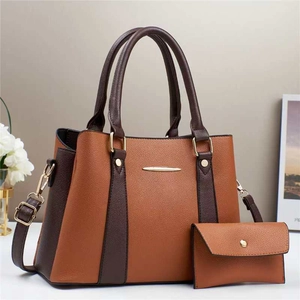 Detail of two-piece tote bag set with brown contrast stitching and gold metal accents