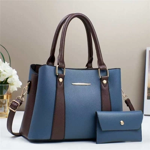 Blue and brown paneled tote bag with matching envelope pouch and golden hardware