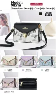 Detailed view of embroidered crossbody bag size 20x7x14cm with golden twist lock