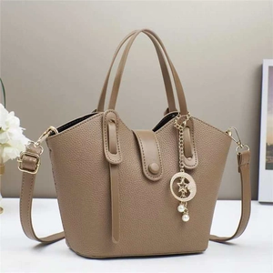 Detail of khaki bucket bag with lychee grain leather and star moon pendant
