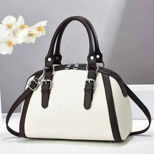 Minimalist beige contrast handbag with dark brown handles and silver hardware