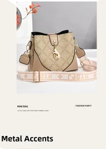Detailed close-up of a beige bucket bag with logo print and gold hardware accent