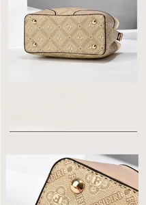 Detail of printed handbag bottom with golden protective metal feet and monogram pattern