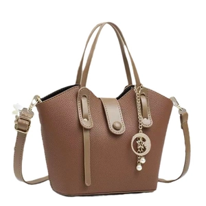 Brown lychee leather bucket bag with top handles, long strap and star-moon charm