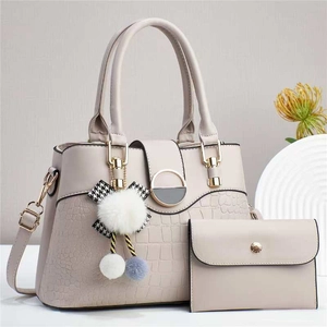 Beige faux leather handbag with crocodile pattern, plush charm and matching wallet