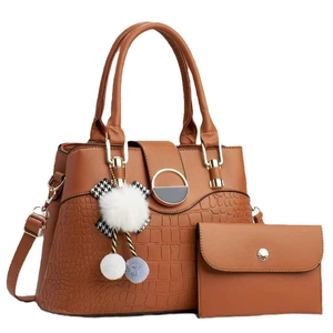 Brown faux leather tote bag with stone pattern detail and stylish pompom charm for women