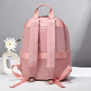 Pink waterproof backpack back detail with luggage strap and padded shoulder straps
