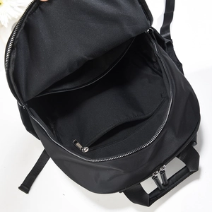 Detailed view of the spacious inner compartments and secure zipper pocket of the black backpack