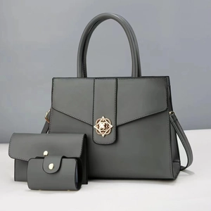 Three-piece grey PU leather tote bag set with metal floral buckle and wallet