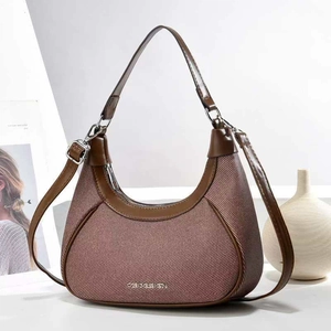 Chic brown crescent moon bag with woven texture and leather trim for stylish women