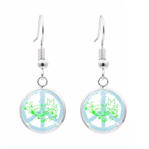 Detail of silver drop earrings with peace sign and green floral glass pendant art