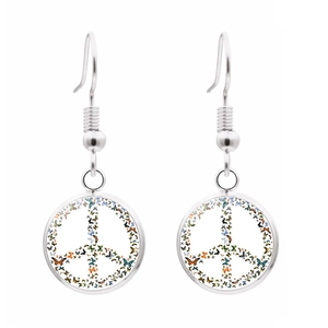 Macro detail of silver peace sign earrings featuring colorful butterfly collage art