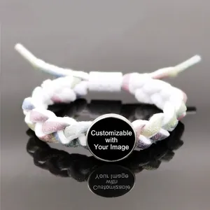 Multicolor braided reflective bracelet for couples with metal charms on a black mirror