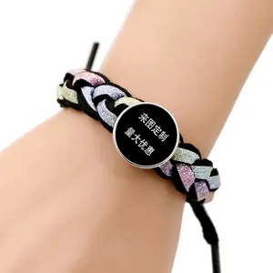 Handmade woven glitter bracelet with customizable round charm on female wrist