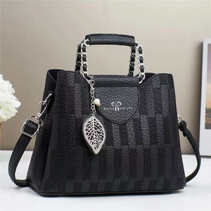 Classic black leather bucket bag with plaid texture, chain handle, and pearl leaf pendant