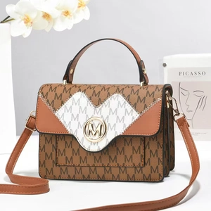 Detail of square handbag with M-pattern leather patchwork and gold metal logo