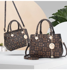 Detail of printed tote bag with circular cut-outs, metal studs, and star charm accessory