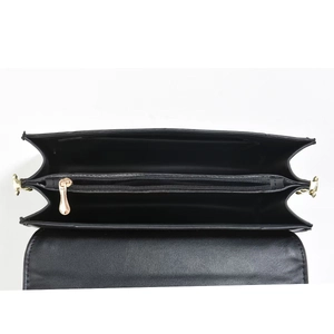 Detail view of the black leather handbag's multi-layered interior and gold zipper pocket