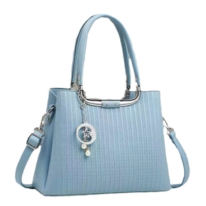 Light blue embossed handbag with star moon pendant and adjustable shoulder strap