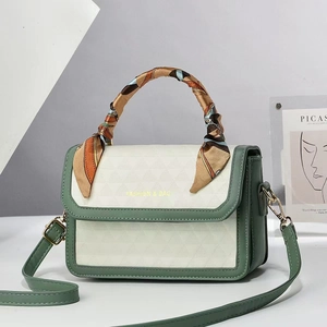 Chic green and beige quilted crossbody bag with silk scarf handle and leather strap