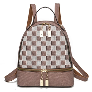 Detail view of mini backpack with brown and silver checkerboard woven texture and gold zippers