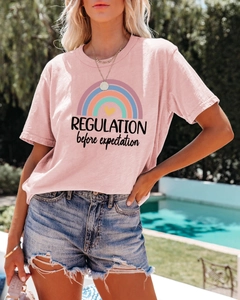 Detail of pink cotton T-shirt featuring a rainbow and heart graphic with text print