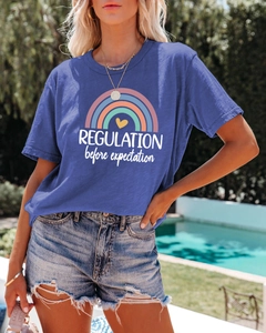 Detail of navy blue women's T-shirt with rainbow print and Regulation text decoration
