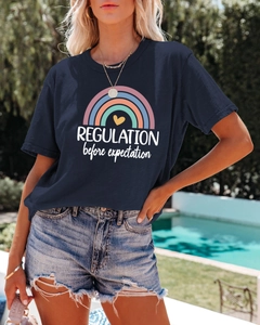 Detailed close-up of blue cotton t-shirt with rainbow print and heart graphic design