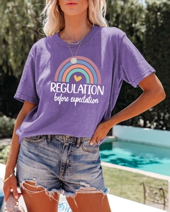 Detail of purple cotton T-shirt featuring rainbow graphic and Regulation print