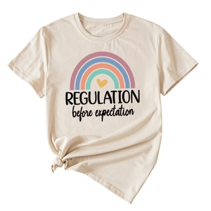 Detail of beige cotton T-shirt featuring rainbow print and Regulation text with a front knot