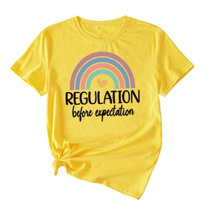 Detail of yellow cotton T-shirt featuring rainbow print and knotted hem for a stylish fit