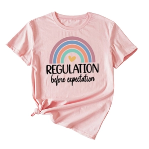 Detail view of pink ladies T-shirt featuring rainbow and regulation text print